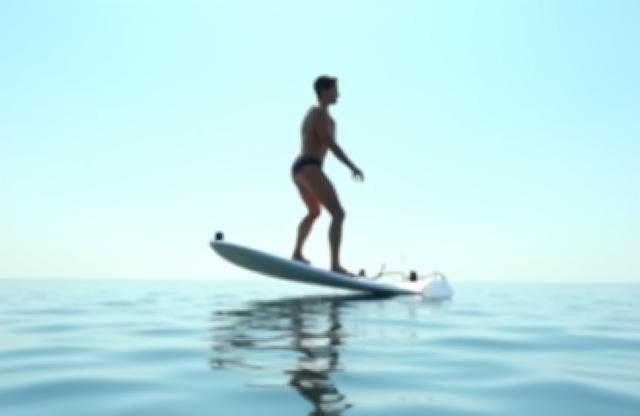 Side profile view of someone riding a hydrofoil e-surf board gracefully